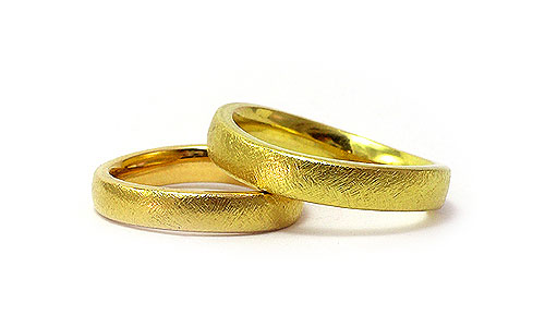 Devine Wave Wedding rings in 18k textured yellow gold by Martinus