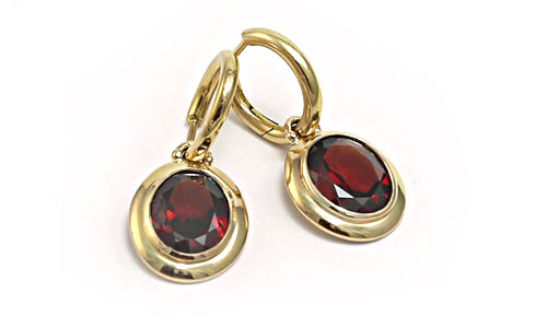 Oval Facetted garnet hoops on yellow gold settings